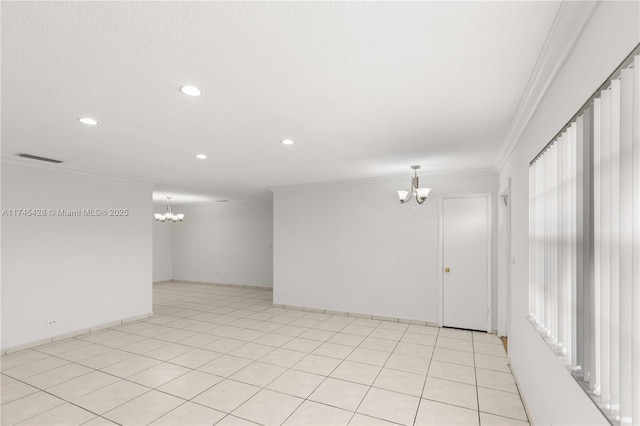 tiled spare room with crown molding, a chandelier, and a textured ceiling