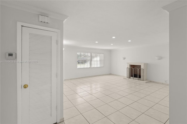 unfurnished living room featuring crown molding and light tile patterned floors