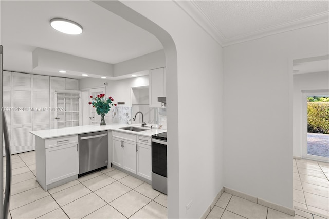 kitchen featuring sink, light tile patterned floors, white cabinetry, stainless steel appliances, and kitchen peninsula