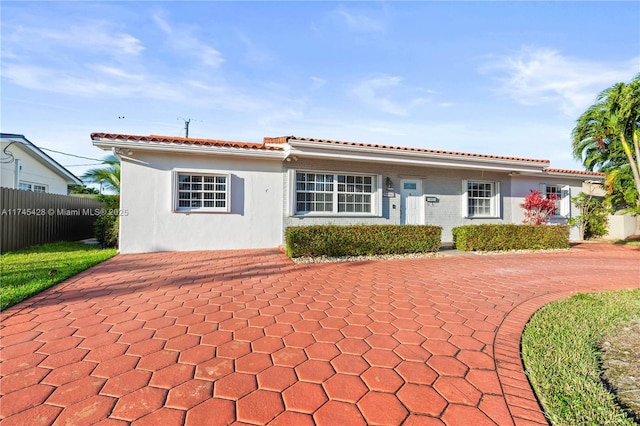 mediterranean / spanish home featuring a patio area