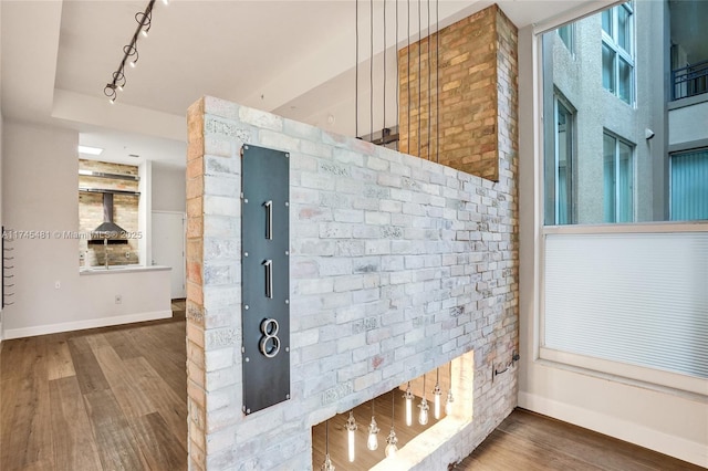 interior details featuring wood-type flooring and track lighting