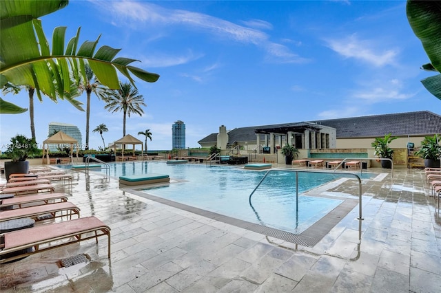 view of pool with a gazebo, a pergola, and a patio area