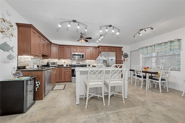 kitchen with backsplash, a center island, and appliances with stainless steel finishes