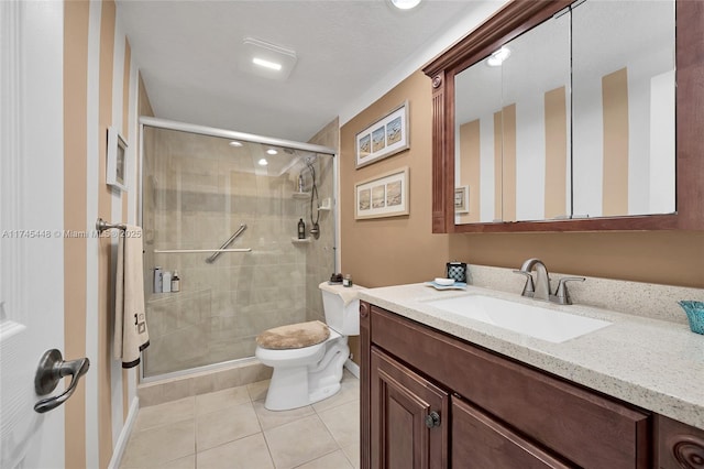 bathroom with vanity, tile patterned floors, a shower with door, and toilet