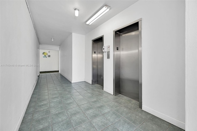 corridor featuring elevator and tile patterned flooring