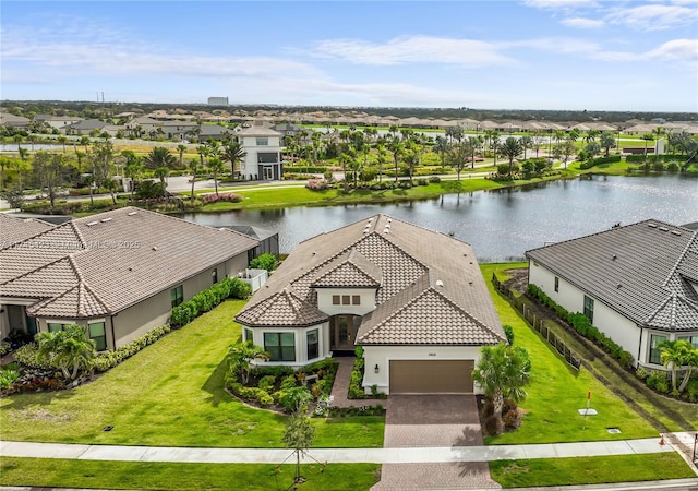 drone / aerial view with a water view and a residential view