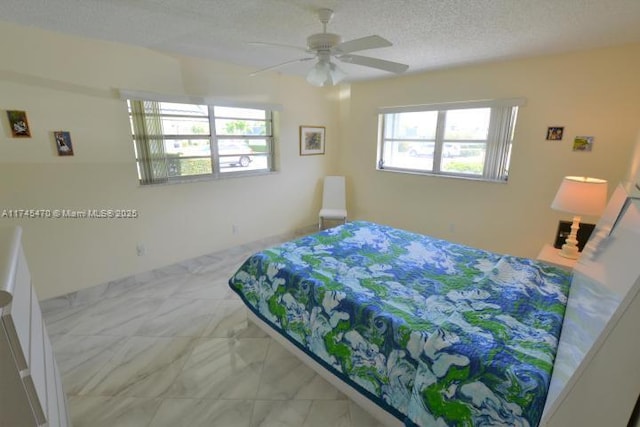 bedroom with ceiling fan and a textured ceiling