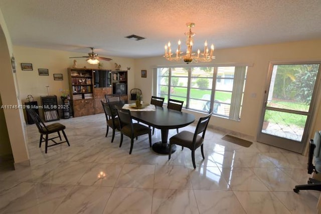 dining room featuring a notable chandelier and a textured ceiling