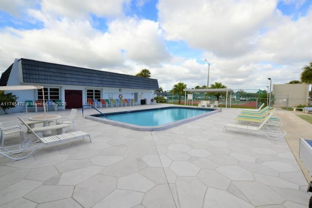 view of swimming pool featuring a patio area