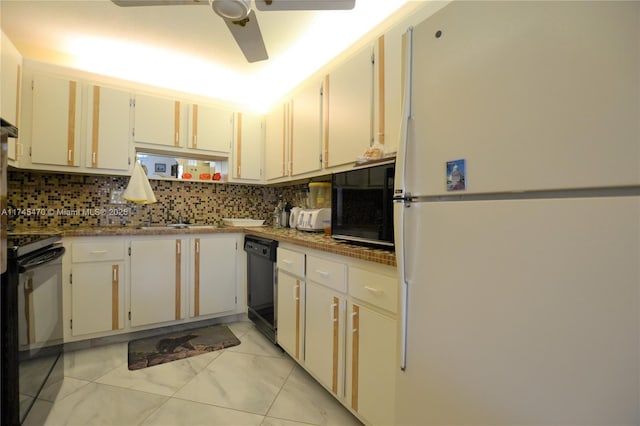 kitchen with white cabinets, sink, decorative backsplash, and black appliances