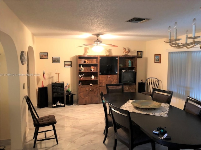 dining room with ceiling fan and a textured ceiling