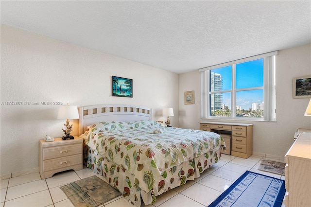 tiled bedroom featuring a textured ceiling