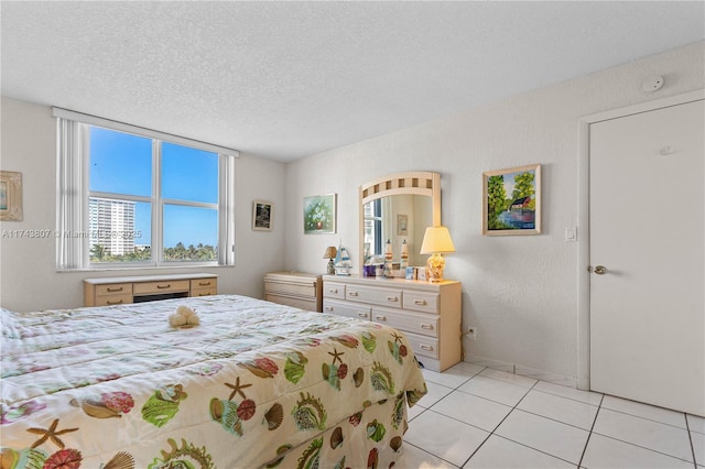 tiled bedroom with a textured ceiling