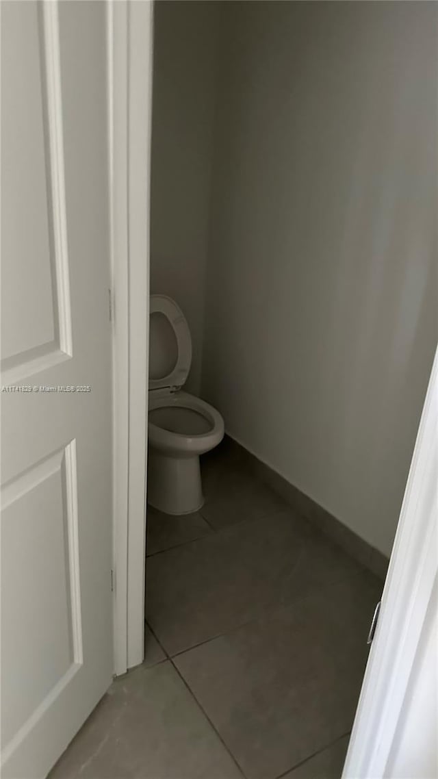 bathroom with tile patterned floors and toilet