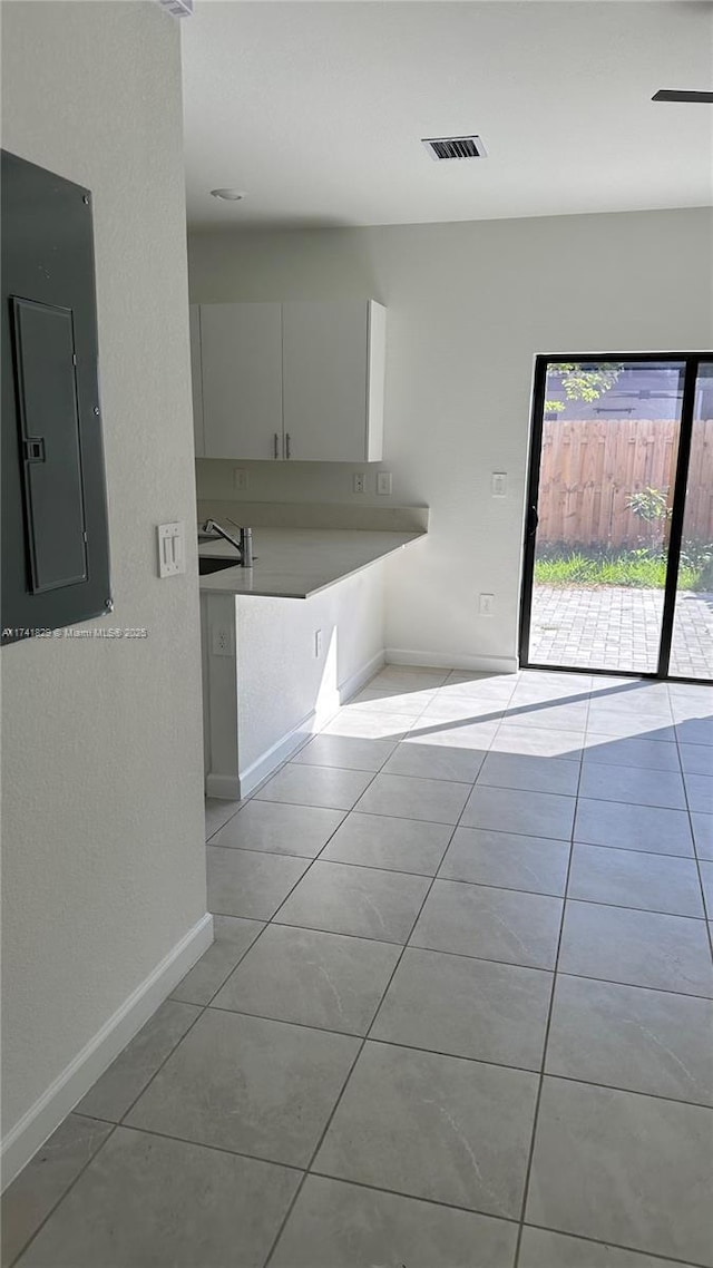 spare room featuring light tile patterned flooring and electric panel