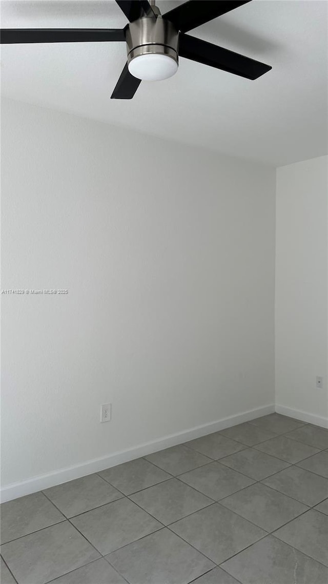 empty room featuring light tile patterned flooring and ceiling fan