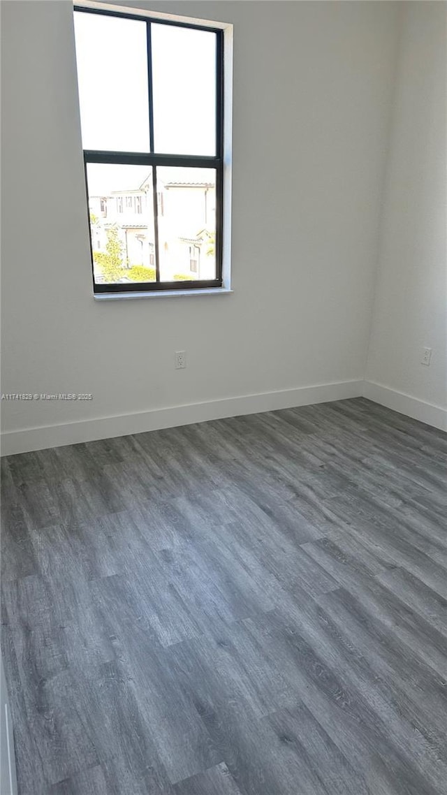 spare room featuring dark hardwood / wood-style flooring