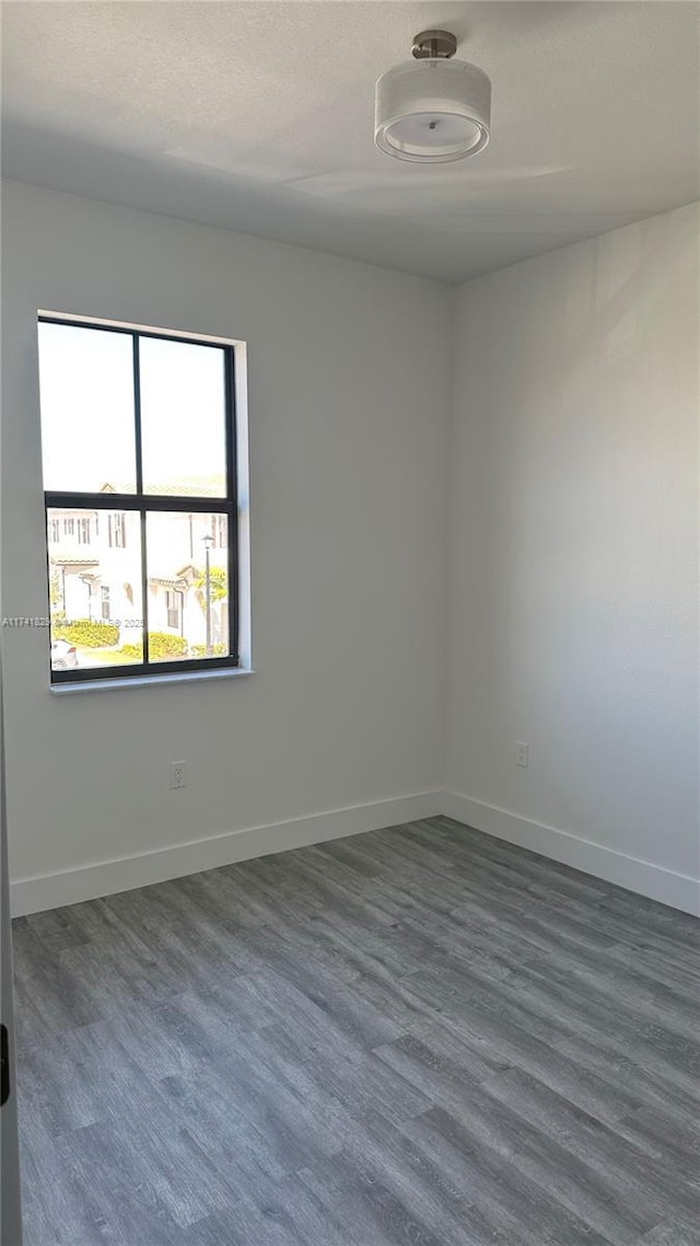 spare room featuring dark hardwood / wood-style flooring