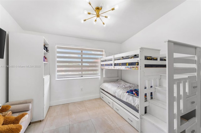 tiled bedroom with vaulted ceiling and a notable chandelier