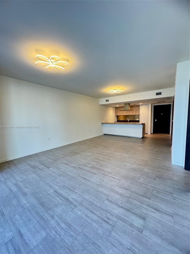 unfurnished living room featuring light wood-type flooring