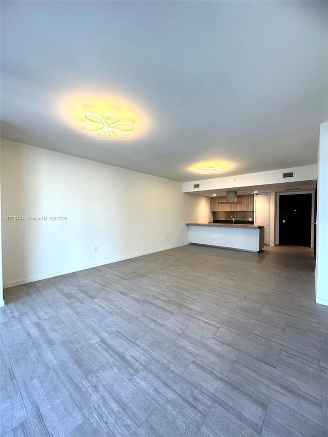 unfurnished living room featuring wood-type flooring