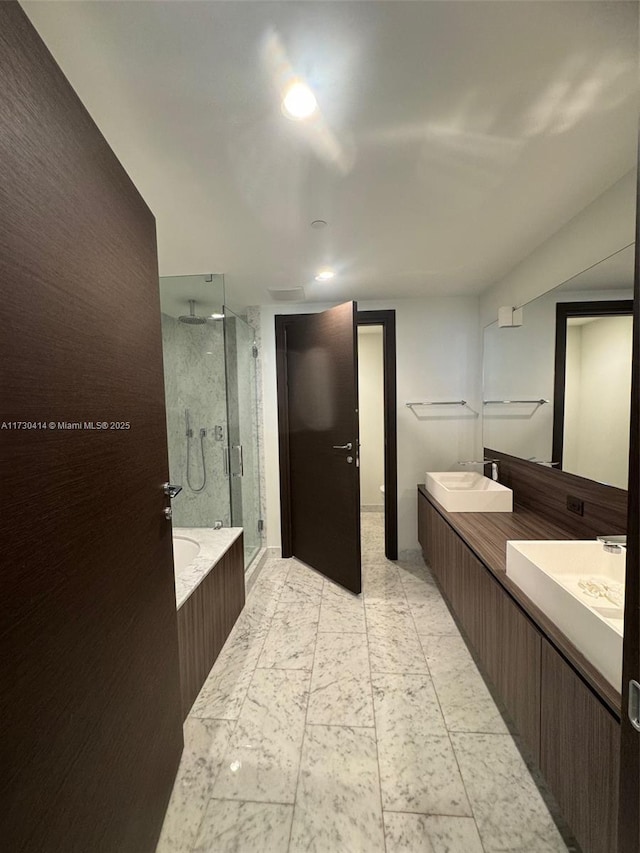 bathroom featuring vanity and separate shower and tub