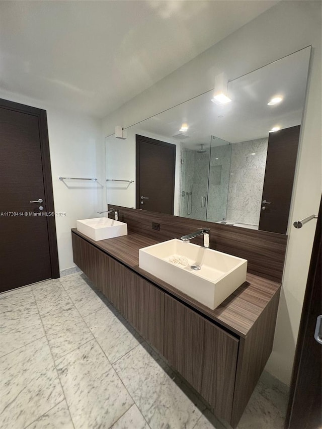 bathroom featuring vanity and a shower with door