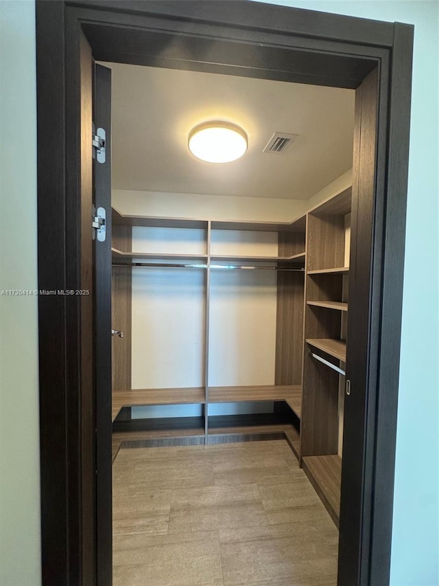 walk in closet featuring hardwood / wood-style flooring