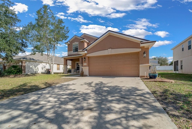 view of front of home featuring a garage, a front lawn, concrete driveway, and stucco siding