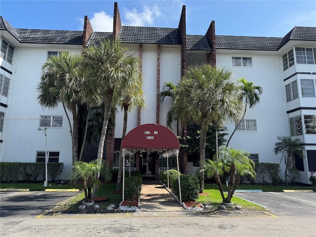 view of building exterior featuring uncovered parking