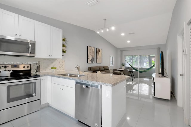 kitchen with white cabinetry, appliances with stainless steel finishes, kitchen peninsula, and sink