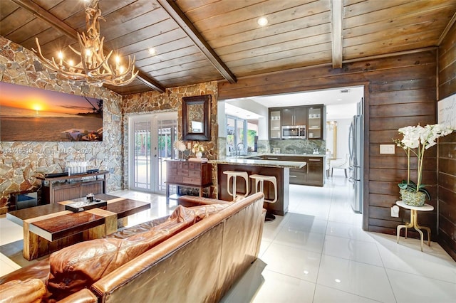 17500 SW 68th Ct, Southwest Ranches, FL 33331 - interior space with wooden ceiling, beamed ceiling, glass insert cabinets, stainless steel appliances, and light tile patterned flooring