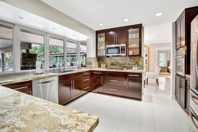 17500 SW 68th Ct, Southwest Ranches, FL 33331 - kitchen with light stone countertops, a sink, stainless steel appliances, recessed lighting, and decorative backsplash