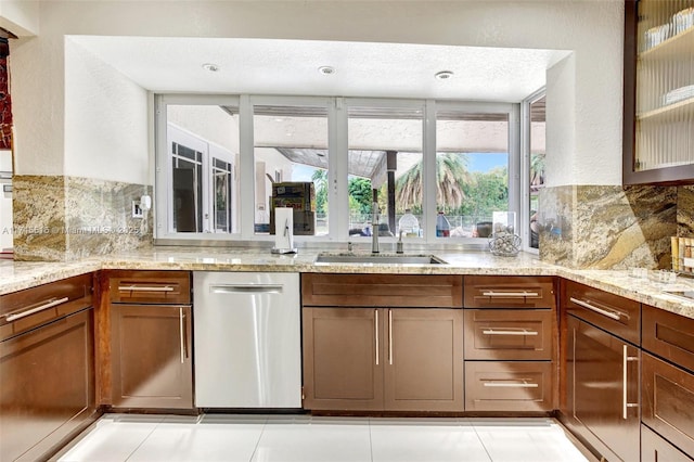 17500 SW 68th Ct, Southwest Ranches, FL 33331 - kitchen featuring light stone countertops, a sink, decorative backsplash, stainless steel dishwasher, and glass insert cabinets