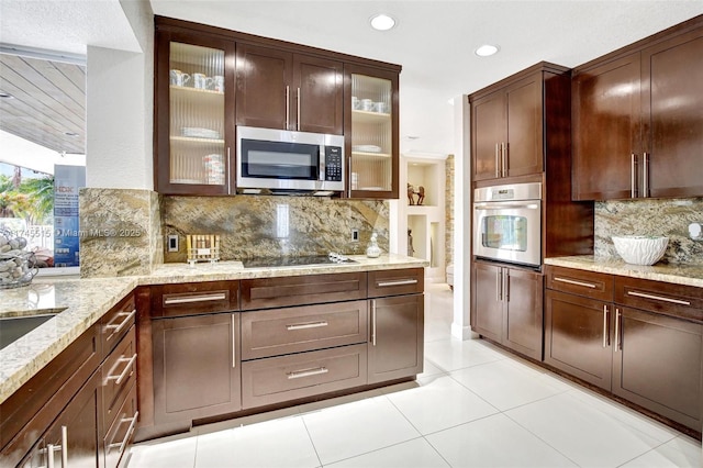 17500 SW 68th Ct, Southwest Ranches, FL 33331 - kitchen with light stone counters, backsplash, light tile patterned floors, and stainless steel appliances