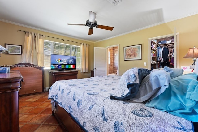 tiled bedroom featuring a walk in closet, crown molding, ceiling fan, a closet, and ensuite bath