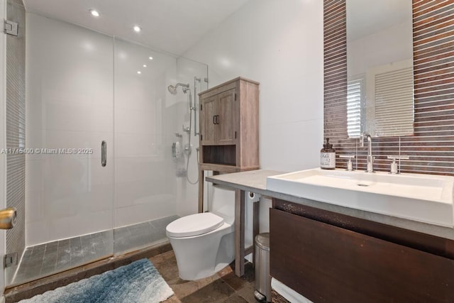 bathroom with vanity, a shower stall, toilet, and recessed lighting