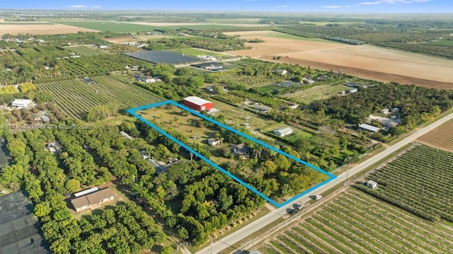 birds eye view of property with a rural view