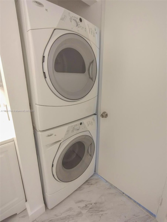 laundry area featuring stacked washer / drying machine