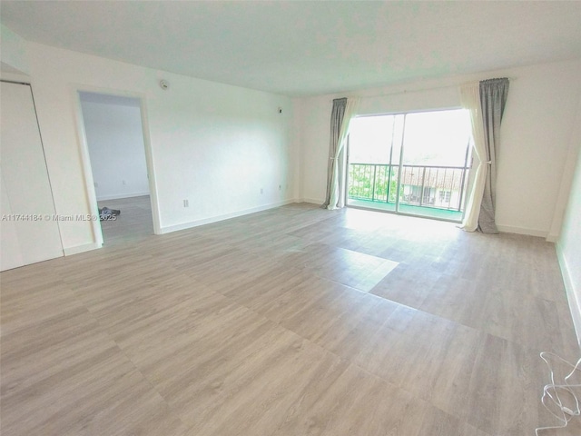 unfurnished room with light hardwood / wood-style floors