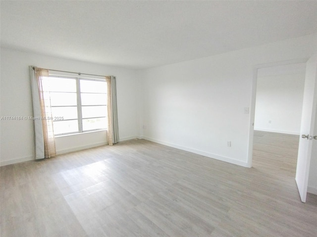 unfurnished room featuring light hardwood / wood-style floors