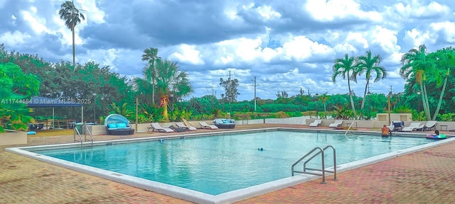 view of pool featuring a patio area