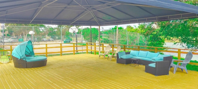 exterior space featuring an outdoor living space, a gazebo, and basketball hoop