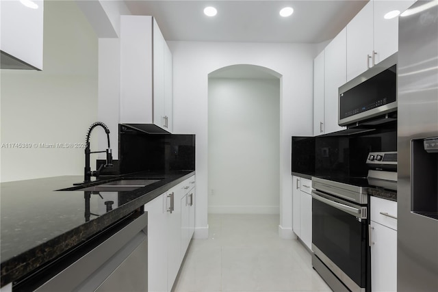 kitchen with stainless steel appliances, sink, and white cabinets