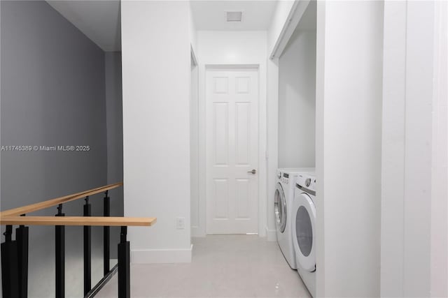 clothes washing area with washing machine and clothes dryer