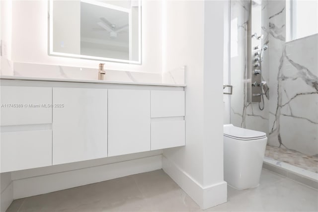 bathroom with vanity, toilet, and tiled shower