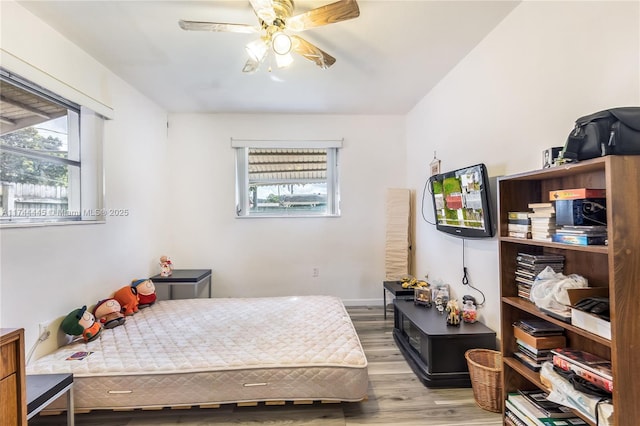 bedroom with ceiling fan and light hardwood / wood-style flooring