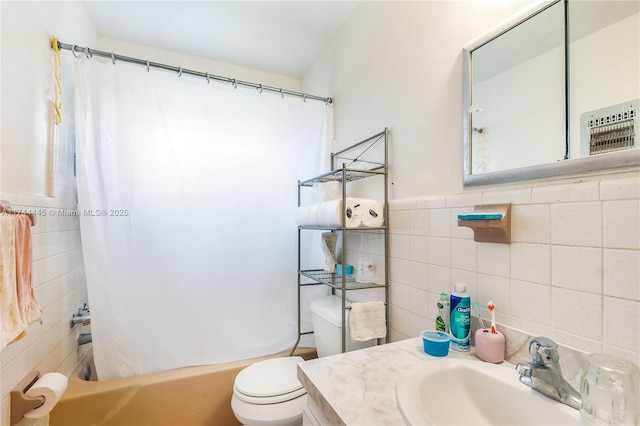 full bathroom with shower / bath combination with curtain, vanity, toilet, and tile walls