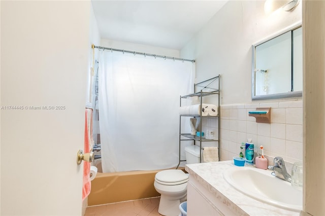 full bathroom featuring tile walls, shower / tub combo, tile patterned flooring, vanity, and toilet