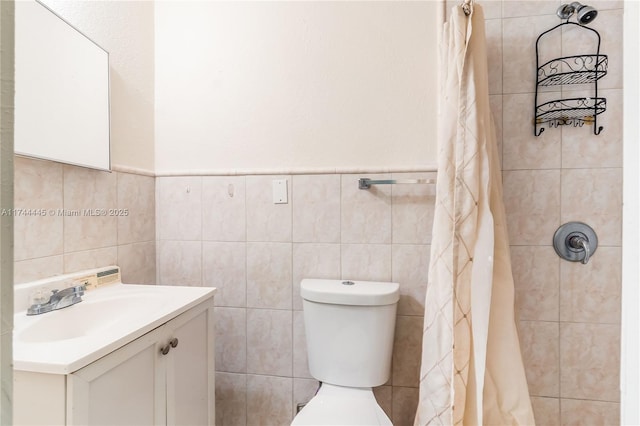 bathroom with vanity, tile walls, a shower with shower curtain, and toilet